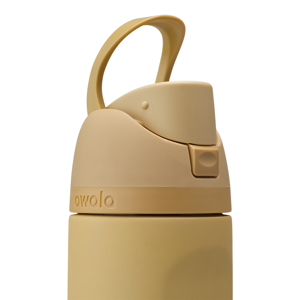 Owala FreeSip 24oz in Autumn Vista, close-up of warm honey-sand lid showing matching carry loop