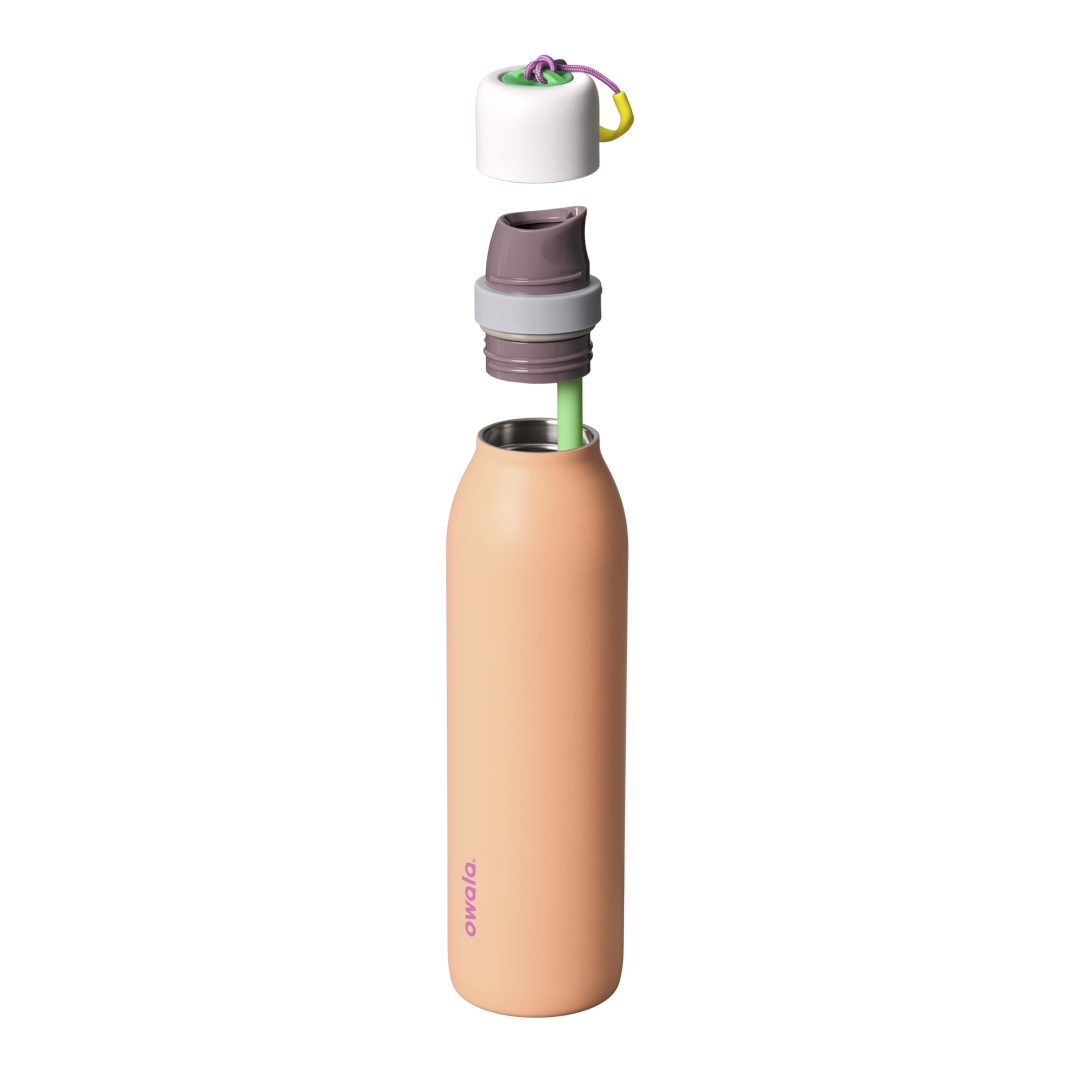 Owala FreeSip Twist 24oz in Peachy Keen, exploded view showing peach-orange body, white twist cap floating above with purple carry string and yellow carry string grip, mauve FreeSip spout, and green straw